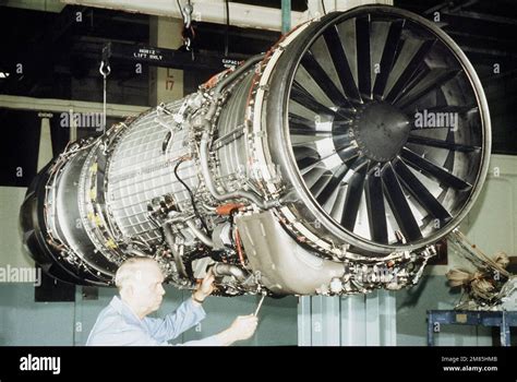 A technician works on the new F-110 turbofan engine to be used in the F ...