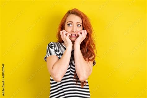 Terrified Young Beautiful Red Haired Woman Wearing Striped Shirt Over