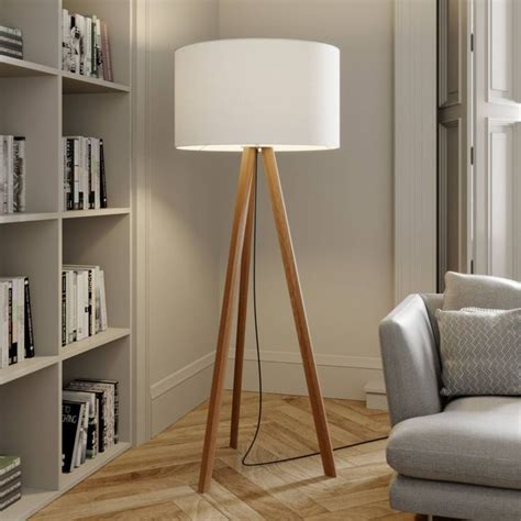 A Living Room With A Chair Lamp And Bookshelf