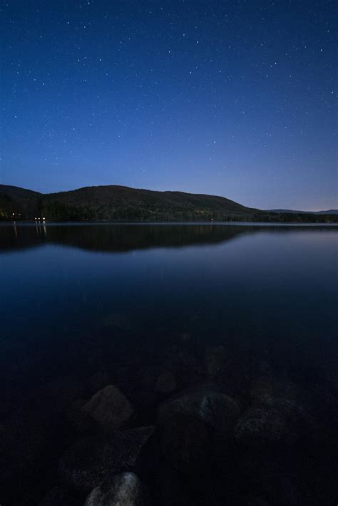 Lake View Under Clear Blue Night Sky during Night Time · Free Stock Photo