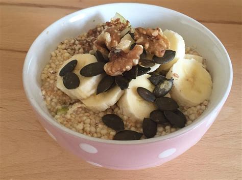 A Bowl Filled With Oatmeal Topped With Bananas And Nuts On Top Of A