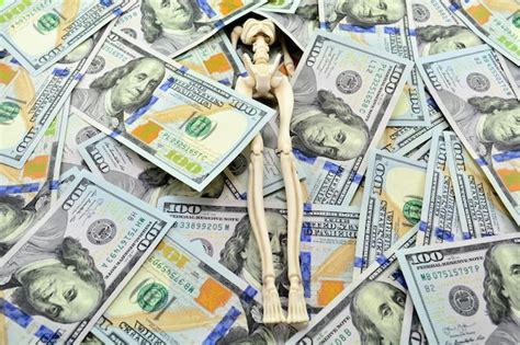 Premium Photo | A pile of cash dollars covers a human skeleton on a ...