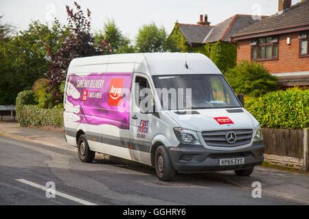 Argos home delivery van in a street with rear door open and man Stock ...