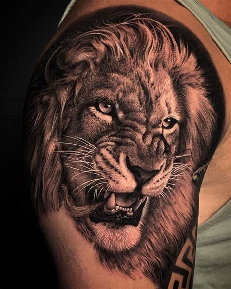 A Man S Arm With A Lion Tattoo On It And His Face Is Shown