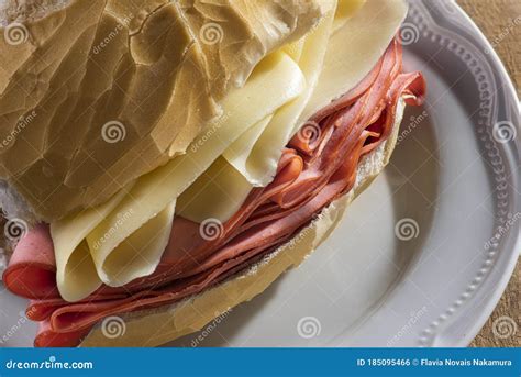 Traditional Mortadella And Cheese Sandwich On A White Plate And Wooden