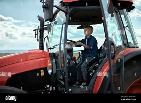 Boy driving tractor hi-res stock photography and images - Alamy