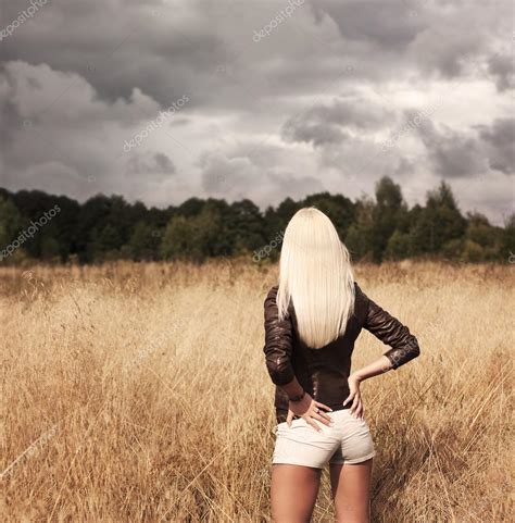 Blonde Woman Posing At The Field Rear View Stock Photo Brickrena