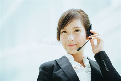 Attractive Asian Businesswoman Wearing A Headphones With Microphone