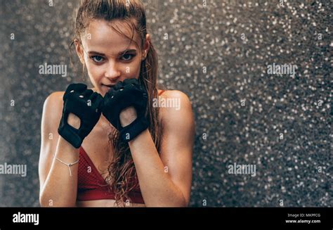 Young Woman Standing In Fighting Stance Female Boxer Exercising