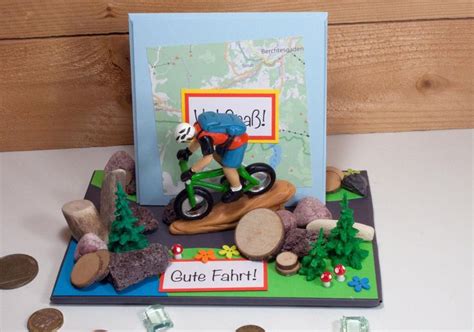 A Birthday Card With A Bike And Trees On It Next To Some Coins That