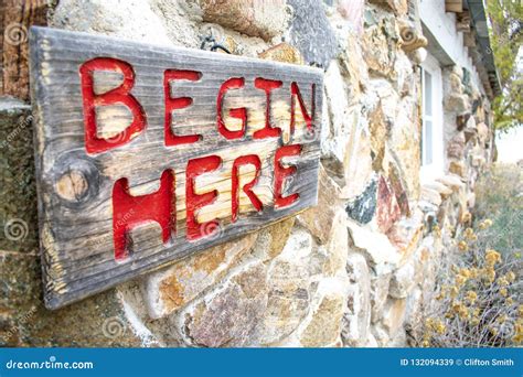 Begin Here Sign On A Rustic Building Stock Image Image Of Window