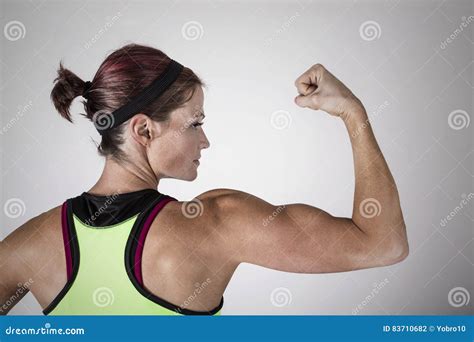 Strong Beautiful Fitness Woman Flexing Her Arm And Back Muscles Stock