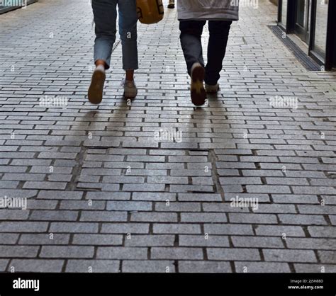 Legs Of Two People Walking Away Stock Photo Alamy