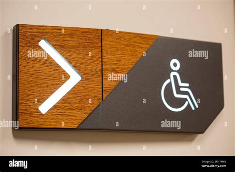 Closeup Of Pwd Comfort Room Signage With An Arrow Sign Showing The