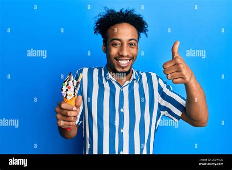 Young African American Man With Beard Eating Ice Cream Smiling Happy