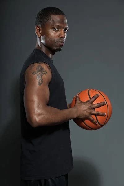 Black american basketball player. Studio portrait isolated on grey ...