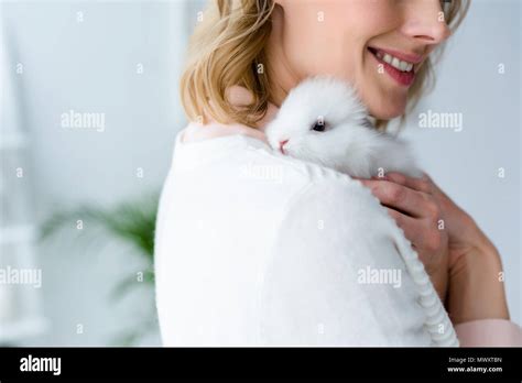 Blonde Woman Hugging White Rabbit Stock Photo Alamy