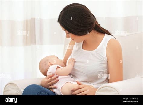 Mother Holding Sleeping Baby At Home Stock Photo Alamy