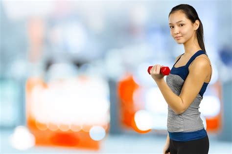 Premium Photo Happy Fitness Woman Lifting Dumbbells