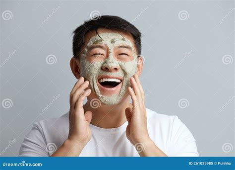 Positive Asian Man Face Mask Relaxed Man On Natural Cosmetic Facial