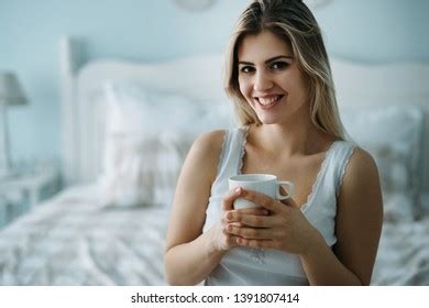 Стоковая фотография 1177460995 Young Beautiful Woman Sitting On Bed