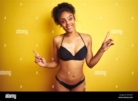African American Woman On Vacation Wearing Bikini Standing Over