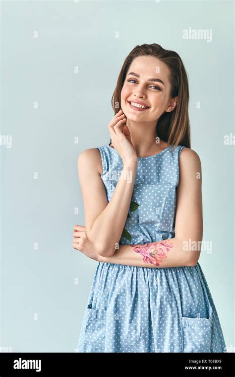 Happy Smiling Beautiful Woman In Polka Dot Dress Posing In Studio