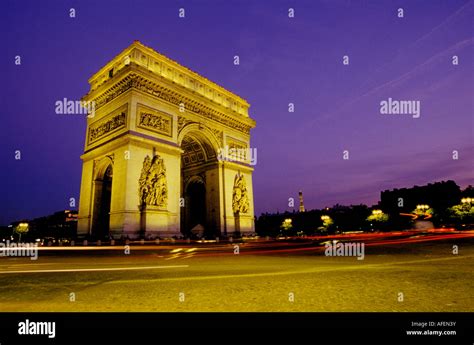 A View At Sunset Of The Arc De Triomphe At The End Of The Avenue Des