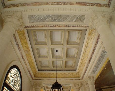 A Chandelier Hangs From The Ceiling In An Ornately Decorated Room With