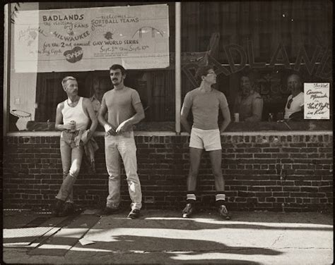 Bar Patrons In Front Of Badlands Bar And Gay World Series Banner