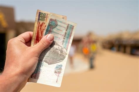 Premium Photo Egyptian Pounds In A Man S Hand On The Background Of