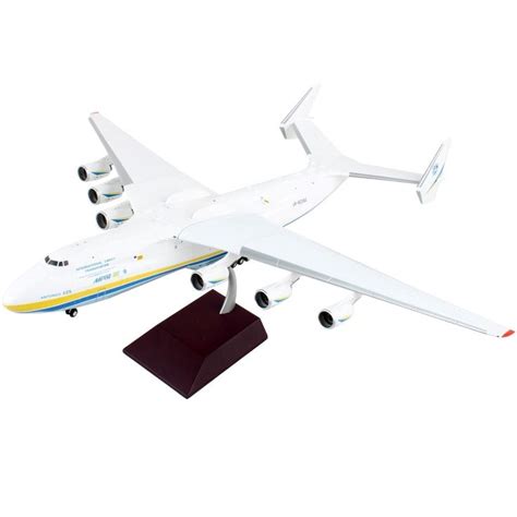 A Model Airplane Is Flying In The Air On A White Background With A