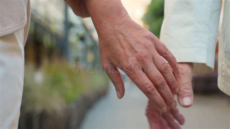 Close Up Holding Hands Couple Together In Park Outdoors Middle Aged