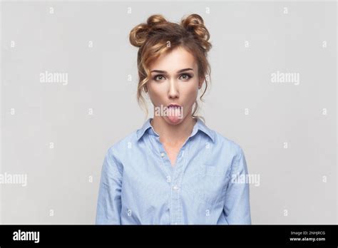 Portrait Of Naughty Comic Blonde Woman Sticking Out Tongue Misbehaves