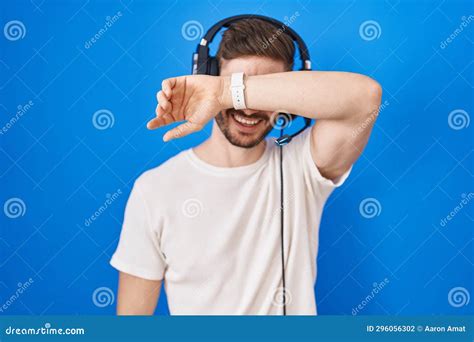 Hispanic Man With Beard Listening To Music Wearing Headphones Covering