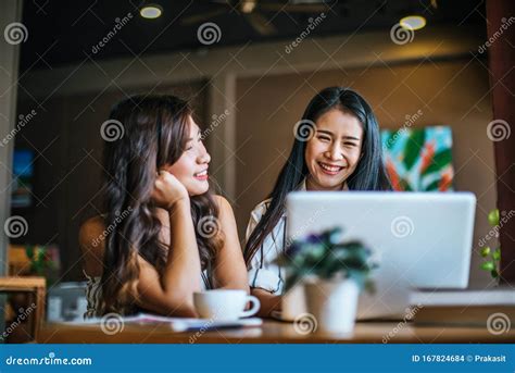 Two Beautiful Women Talking Everything Together At Coffee Shop Stock