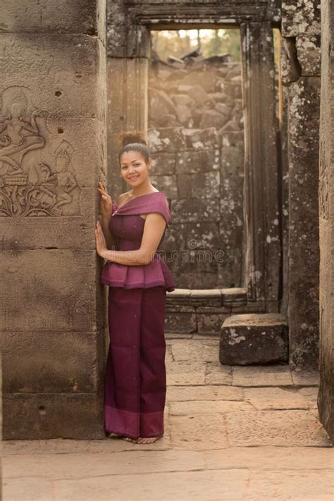 Cambodian Girl In Khmer Dress Standing In Bayon Temple In Angkor City