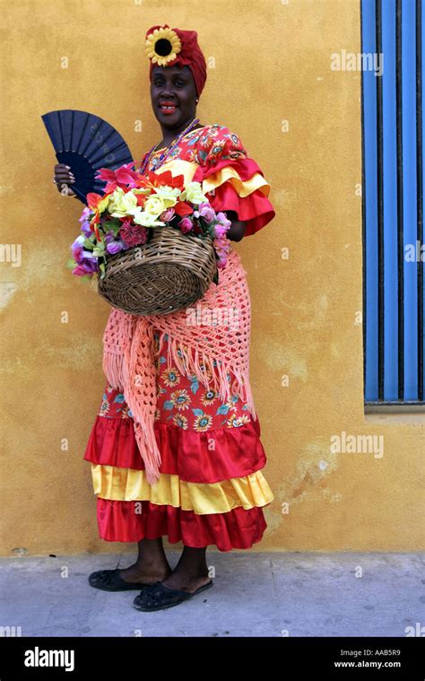 Local Cuban Woman In Traditional Dress Allows Tourists To Photograph