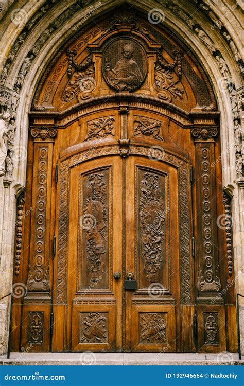 Heavy Wooden Doors with Carved Figures, Designs and Symbols Under an ...