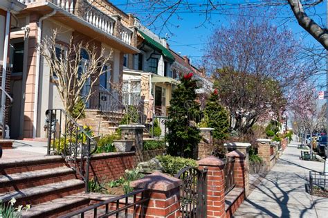 Row Of Neighborhood Homes With Green Plants During Spring In Astoria