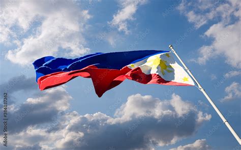 Philippine National Flag Waving In The Wind Against Blue Cloudy Dusk