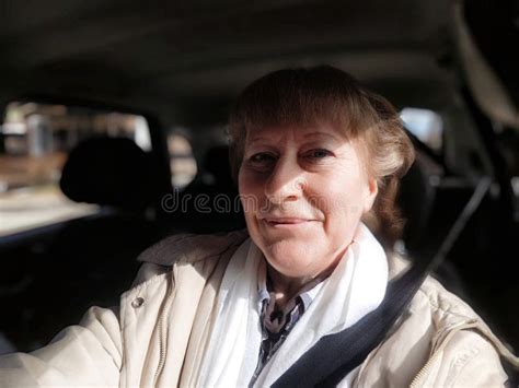 Middle Aged Blonde Woman Enjoys A Scenic Drive During Her Travel Adventure While Capturing A