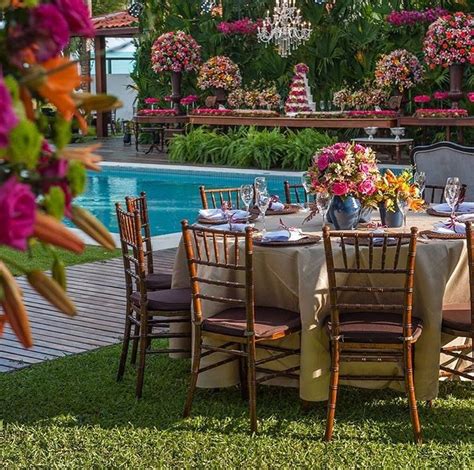 An Outdoor Table Set Up For A Formal Dinner By The Swimming Pool With