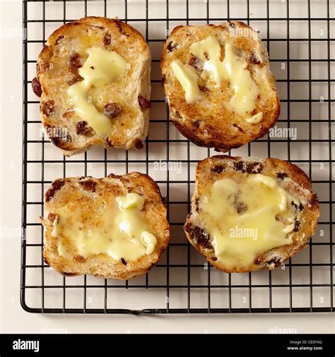 Four Buttered Toasted Hot Cross Buns On Wire Rack Stock Photo Alamy