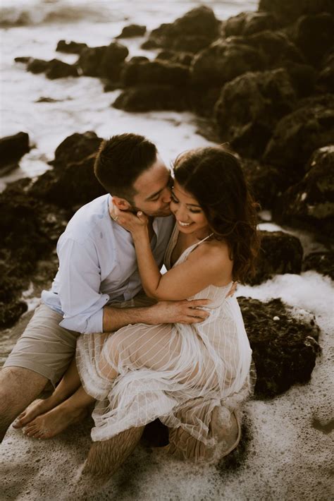 Beach Engagement Shoot In The Water By Rocks Engagement Pictures