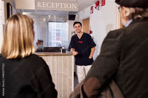 Patients and doctor at reception desk Stock Photo | Adobe Stock