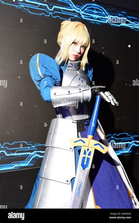 A Chinese Showgirl Dressed In Cosplay Costume Featuring Saber Whose