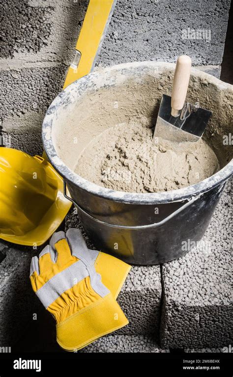 Tools For Bricklayer Bucket With A Solution And A Trowel Close Up