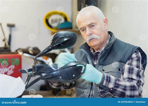 Senior Mechanic Assessing Broken Scooter Stock Photo Image Of Examine