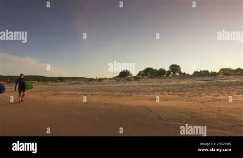 Two Surfers Man Woman Walking On Beach At Sunset Romantic Couple Sports